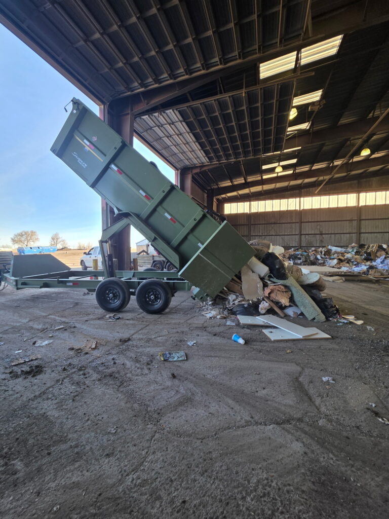 high country junk removal and hauling trailer tilted unloading junk in colorado springs 1.jpeg